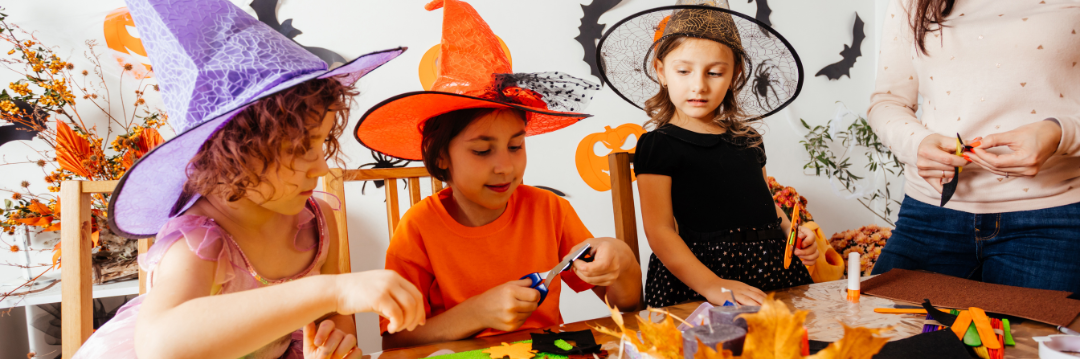 Kids (toddlers) playing with halloween crafts in costumes