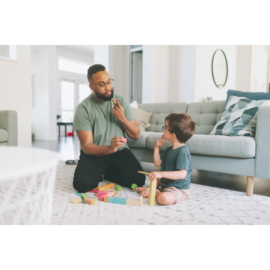 Men teaching toddler ASL
